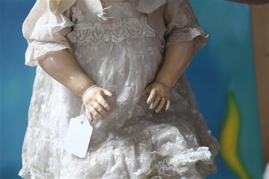 A Kestner 192 doll, fixed wrists, pierced ears and hairline to forehead, 24in.